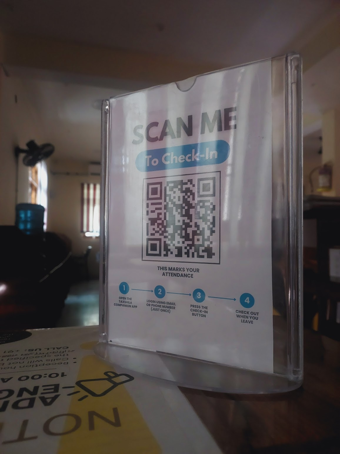 The check-in QR stand on the reception desk